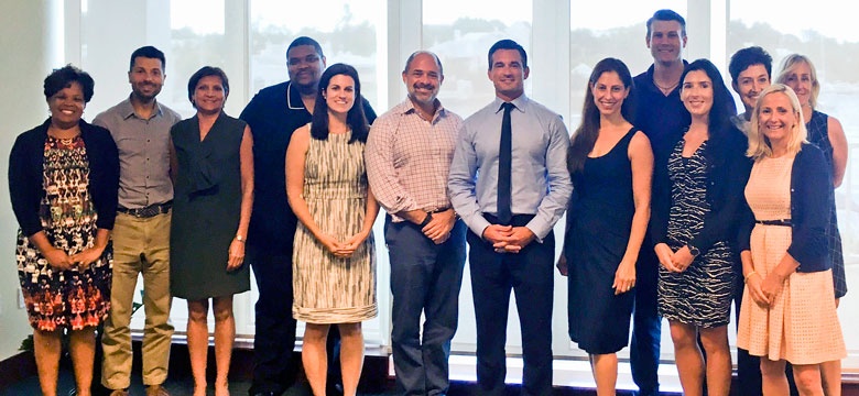 Minister Baron and Stephen Weinstein (centre) with members of the Bermuda RenaissainceRe team